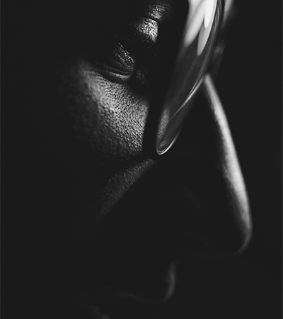 Close-up of a person's face with a magnifying glass, representing client empowerment using marketing technology for self-directed campaigns in Spring, Texas.